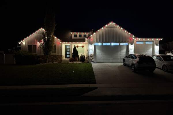 Christmas lights on a ranch home at night in Utah County